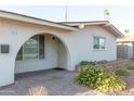 Welcoming front entrance featuring an arched doorway, brick-paved walkway, and beautiful desert landscaping at 1894 E Julie Dr, Tempe, AZ 85283