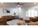 Comfortable living room featuring hardwood floors, neutral walls, and ample natural light from large windows at 1894 E Julie Dr, Tempe, AZ 85283