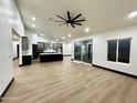 Open concept living space with wood flooring, recessed lighting, and a large sliding glass door to the outside at 22504 W Meade Ln, Buckeye, AZ 85326