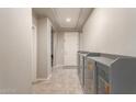 Bright entryway with neutral paint, tiled flooring, and built-in storage cabinets at 22660 N 122Nd Ave, Sun City, AZ 85373