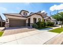 Beautiful exterior view of home featuring an attached garage, landscaped yard, and covered porch at 2716 S Chatsworth --, Mesa, AZ 85209