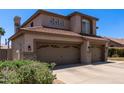 A view of the home with a three-car garage and a landscaped yard at 3089 E Indigo Bay Dr, Gilbert, AZ 85234