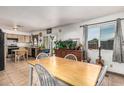 Bright dining area features tile floors, large window, and an aquarium at 3208 W Wagoner Rd, Phoenix, AZ 85053