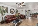 Inviting living room featuring tile flooring, comfortable leather seating, and decorative accents at 3208 W Wagoner Rd, Phoenix, AZ 85053