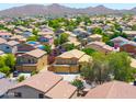 Expansive view of a suburban neighborhood with neat homes and lush trees in the distance at 3511 W Allens Peak Dr, San Tan Valley, AZ 85144