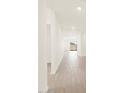 Bright hallway featuring tile flooring and neutral walls leading to the living area at 3845 N Camden Dr, Florence, AZ 85132