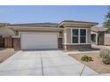 Charming single-story home featuring a two-car garage and low maintenance desert landscaping at 41279 W Elm Dr, Maricopa, AZ 85138