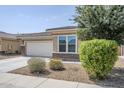 Charming single-story home with desert landscaping and tree in the front yard at 41279 W Elm Dr, Maricopa, AZ 85138