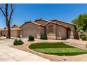 Well-presented one-story house showcasing neat landscaping and an attached two-car garage at 42458 W Desert Fairways Dr, Maricopa, AZ 85138