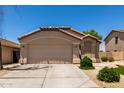 Charming single-level home with a neutral-colored exterior and a convenient two-car garage at 42458 W Desert Fairways Dr, Maricopa, AZ 85138