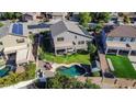 An aerial view of a home showcasing the backyard pool, landscaping, and surrounding neighborhood at 4408 W Summerside Rd, Laveen, AZ 85339