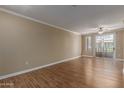 Bright and airy living room featuring a sliding glass door and attractive and durable laminate flooring at 4465 E Paradise Village S Pkwy # 1224, Phoenix, AZ 85032