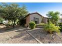 Attractive single-story home with desert landscaping and well-manicured greenery at 4548 E Nightingale Ln, Gilbert, AZ 85298