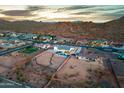 Aerial view of a property with a pool, surrounded by desert landscape and the outline of the property at 460 W Chase St, San Tan Valley, AZ 85143