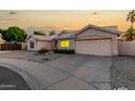 Inviting single-story home with mature desert landscaping and attached two-car garage and circle driveway at 462 N Bedford Ct, Chandler, AZ 85225