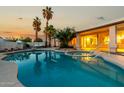 Backyard featuring a large pool with a spa, patio, desert landscaping, and a covered patio at 462 N Bedford Ct, Chandler, AZ 85225