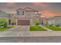 Charming two-story home with a well-manicured lawn and a warm sunset backdrop at 550 E Zion Pl, Chandler, AZ 85249