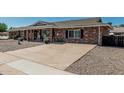 Charming single-story brick home featuring desert landscaping with a concrete driveway at 6247 E Albany St, Mesa, AZ 85205