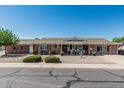 Charming single-story brick home featuring desert landscaping and a welcoming front porch area at 6247 E Albany St, Mesa, AZ 85205