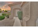 Charming front entrance with an arched entryway and well-maintained landscaping at 7207 W Alta Vista Rd, Laveen, AZ 85339