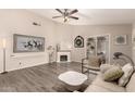 Spacious living room featuring a fireplace, modern decor, and vinyl flooring at 7826 W Mcrae Way, Glendale, AZ 85308