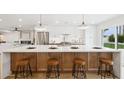 Bright kitchen with an expansive island, stylish seating, and stainless steel appliances for modern living at 8403 E Fairmount Ave, Scottsdale, AZ 85251