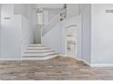 Spacious foyer featuring a staircase, hardwood floors, and an open layout leading to the kitchen and living areas at 8750 W Granada Rd, Phoenix, AZ 85037