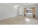 Inviting living room featuring neutral paint, tile floors, and large window with lots of light at 9420 S 35Th Gln, Laveen, AZ 85339