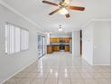 Open-concept living space flowing into a kitchen with wood cabinets and stainless steel appliances at 9420 S 35Th Gln, Laveen, AZ 85339