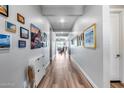 Long hallway with light flooring and picture frames at 1202 E Nolan Pl, Chandler, AZ 85249