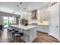 Open kitchen featuring white cabinets, quartz countertops, island with seating, and stainless steel appliances at 1202 E Nolan Pl, Chandler, AZ 85249