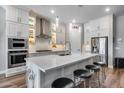 Modern kitchen features an island with barstool seating, stainless steel appliances, and modern cabinets at 1202 E Nolan Pl, Chandler, AZ 85249