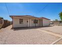 Single-story home with a gravel front yard and a sidewalk leading to the front door at 122 N 5Th St, Avondale, AZ 85323