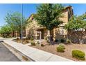 Attractive front view of a stucco home with mature trees, landscaping, and sidewalk at 1528 N Balboa --, Mesa, AZ 85205