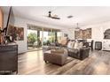 Bright living room featuring stylish decor, wood flooring, and sliding glass doors to the backyard at 1528 N Balboa --, Mesa, AZ 85205