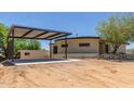 Charming single story home shows carport with stone accents and desert landscaping at 1545 E Christy Dr, Phoenix, AZ 85020