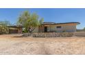 Unique home boasts desert landscaping, carport, and stone accents for rustic desert charm at 1545 E Christy Dr, Phoenix, AZ 85020