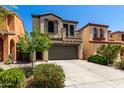 Charming two-story home with desert landscaping and a driveway leading to a two-car garage at 1612 W Lacewood Pl, Phoenix, AZ 85045