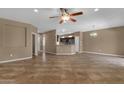 Spacious living room showcasing tile flooring, neutral wall color, open layout, and natural light with ceiling fan at 16525 W Tranquility Ln, Surprise, AZ 85387