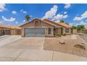 Attractive single-story house boasting desert landscaping, a two-car garage, and a quaint entryway under a bright sky at 1672 W Butler Dr, Chandler, AZ 85224