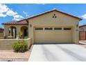 Charming home featuring desert landscaping, covered porch, and a two-car garage at 16756 S 181St Ln, Goodyear, AZ 85338