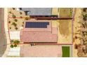 An aerial view of a single Gathering home with solar panels and defined property lines at 16824 W Alice Ave, Waddell, AZ 85355
