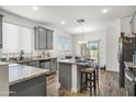 Modern kitchen with granite countertops, gray cabinets, and stainless steel appliances at 16824 W Alice Ave, Waddell, AZ 85355