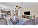 Open-concept living room with tile flooring, ceiling fans, and neutral paint at 17425 N 1St Dr, Phoenix, AZ 85023
