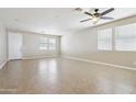 Spacious living room featuring neutral walls, tile flooring, and a ceiling fan at 19182 N Smith Dr, Maricopa, AZ 85139
