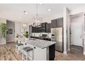 Open kitchen featuring granite countertops, stainless steel appliances, and a large center island at 2065 N Red Clf, Mesa, AZ 85207