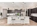 Spacious kitchen with a large island, pendant lighting, and stainless steel appliances at 2065 N Red Clf, Mesa, AZ 85207