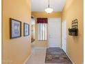 Inviting entryway with neutral walls, tiled floor, and charming decor creates a warm welcome at 2124 W Harwell Rd, Phoenix, AZ 85041
