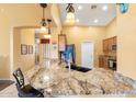 Open kitchen with granite counters, pendant lights, and ample cabinet space for storage at 2124 W Harwell Rd, Phoenix, AZ 85041
