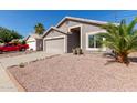 Charming single-story home with a two-car garage and low maintenance desert landscaping at 22039 N 35Th Dr, Glendale, AZ 85310